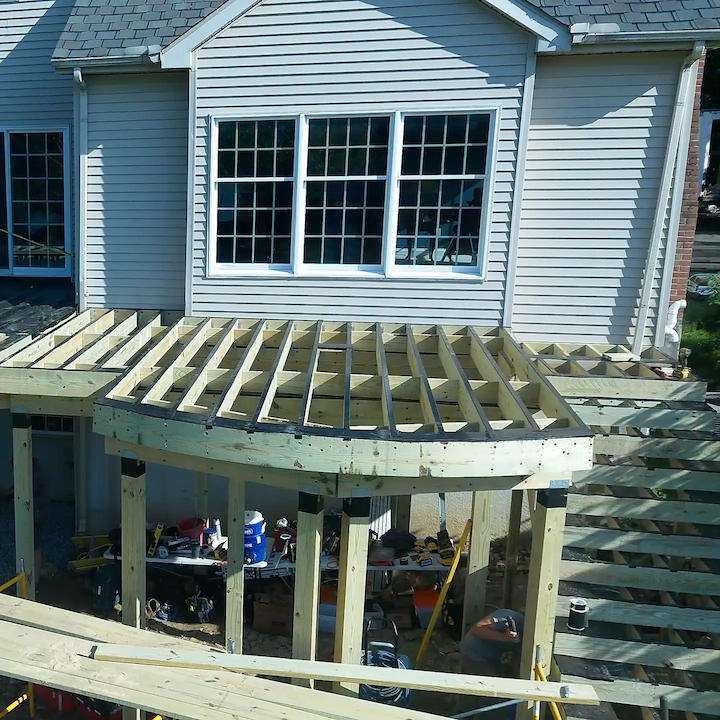 Pressure-treated deck joists and framing built to code -- the structure underneath that holds everything up