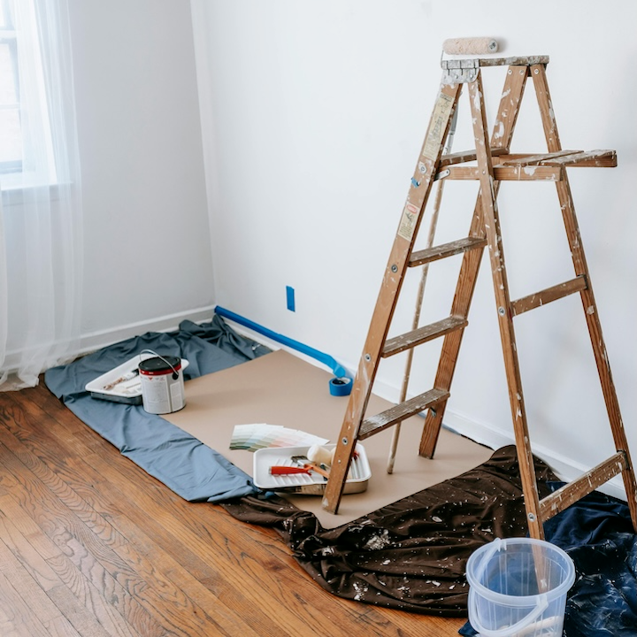 Drop cloths, ladder, and prep supplies staged before painting -- the work that separates a good job from a callback